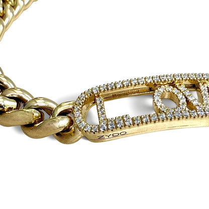 Angled detail of the Amore Dorato bracelet showing diamond-set letters and the ZYDO signature engraved along the yellow gold frame.