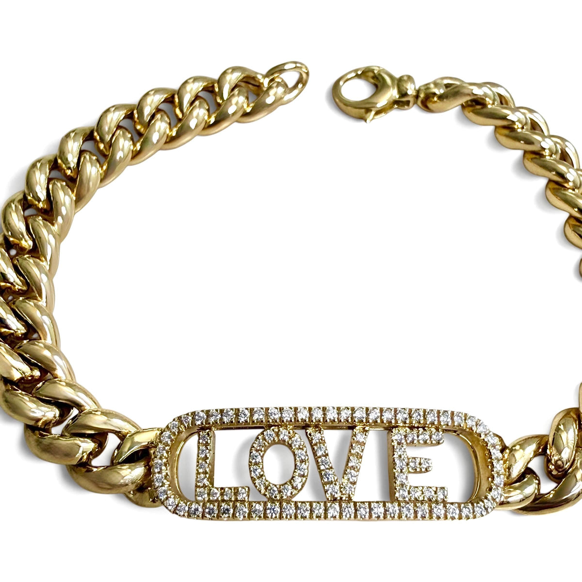Overhead detail of the unfastened ZYDO Amore Dorato bracelet, showing diamond LOVE letters, yellow gold curb links, an end ring and lobster clasp.