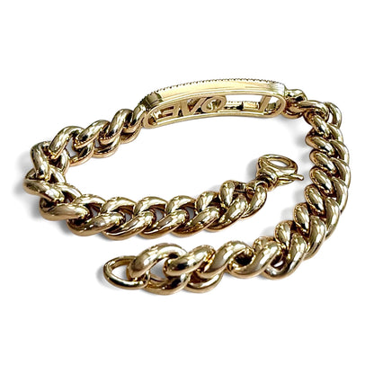 ZYDO Amore Dorato bracelet shown unfastened from the back, with yellow gold curb links, a lobster clasp and the reverse of the LOVE centerpiece.