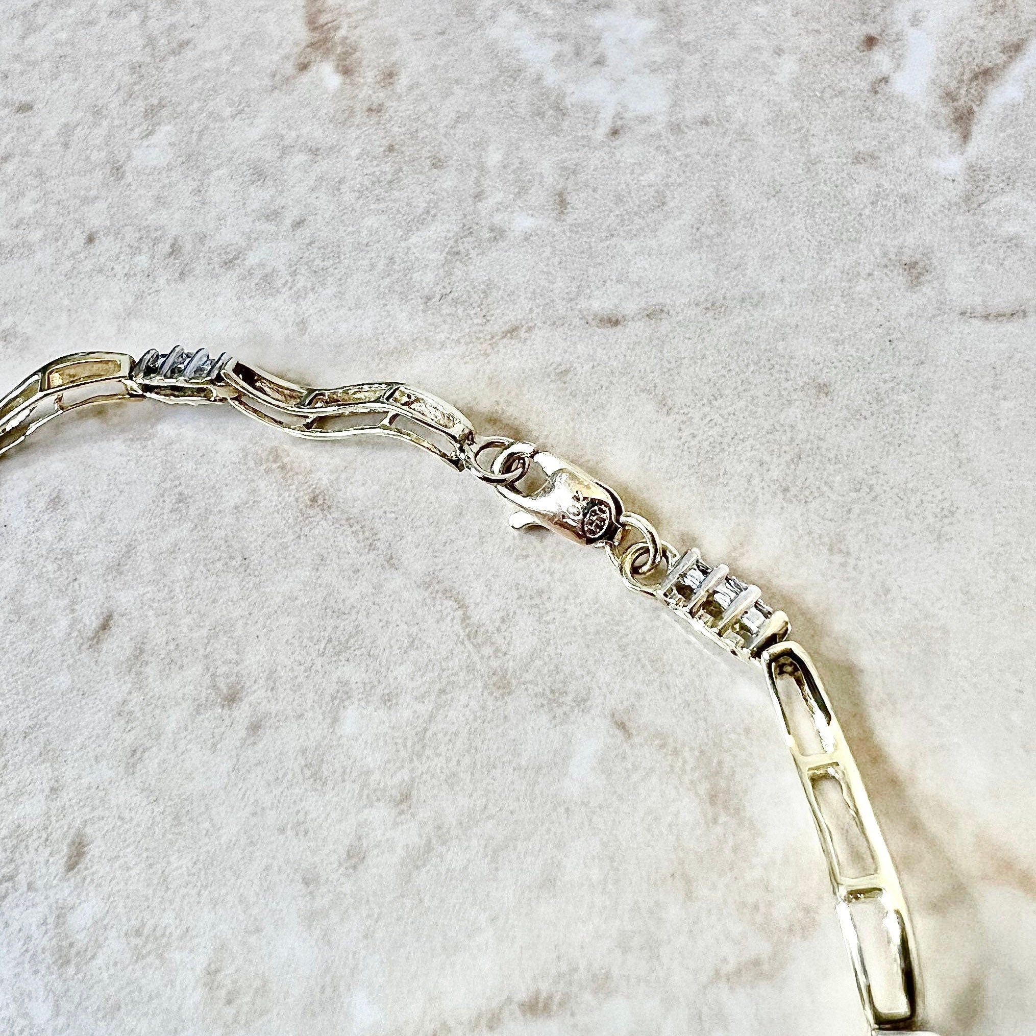 Sold at Auction: 10 Carat Gold Diamond Charm Bracelet